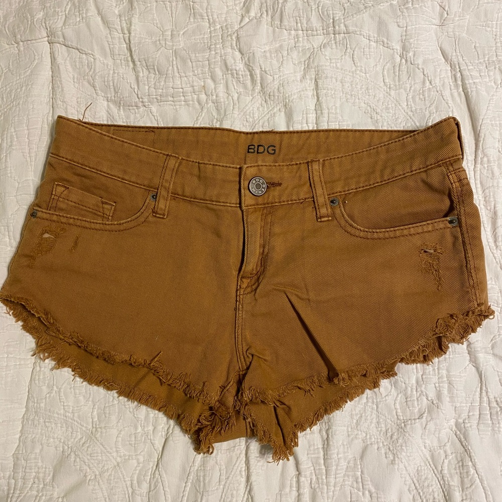 Tan low rise dolphin denim shorts
